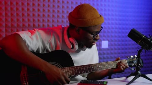 Man Plays Guitar in Music Recording Studio