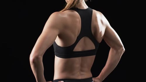 Fit Woman Turns To Look at Camera