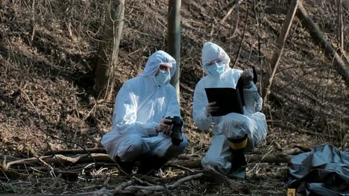 Forensic Specialist Working in the Forest Police Criminalists Collecting Evidence and Making
