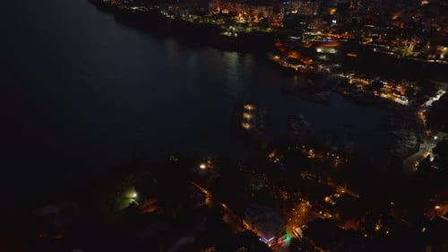 High Angle View of City Marina Tilt Up Reveal Buildings in Surrounding Boroughs Along Sea Coast at