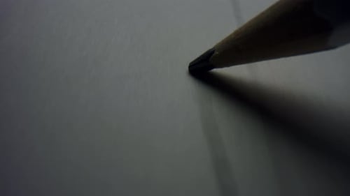 Pencil Tip Drawing a Line on White Paper