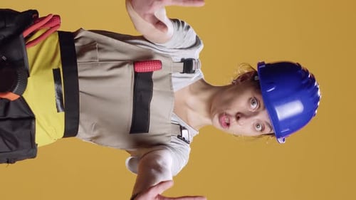 Vertical Video Portrait of Construction Worker Doing Stop Sign with Palm