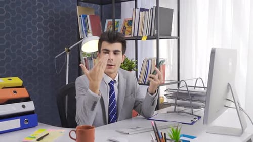 Office manager talking to business partner on smartphone or in company workspace.