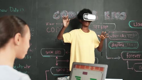 African boy using VR glasses while young woman looking at camera. Edification