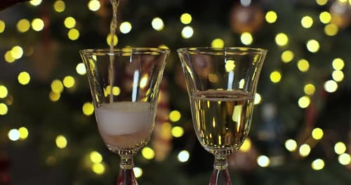 Champagne Being Poured into Christmas Glasses