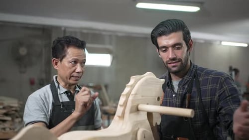 Carpenters are working at workshop.