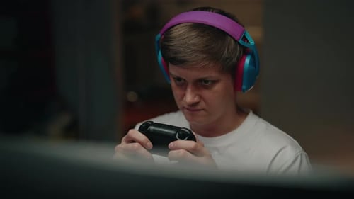 Young man playing video games at home