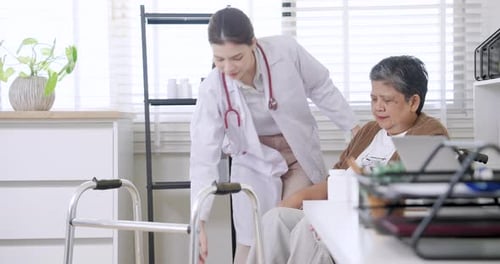 Doctor Assists Senior Patient with Walker