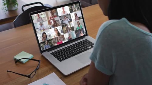 African american woman having a video conference with office colleague on laptop