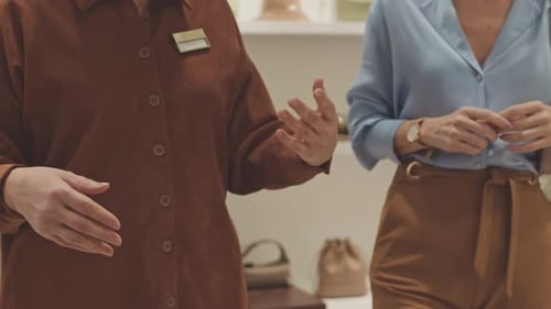 Shop Assistant Consulting Customer in Clothes Boutique