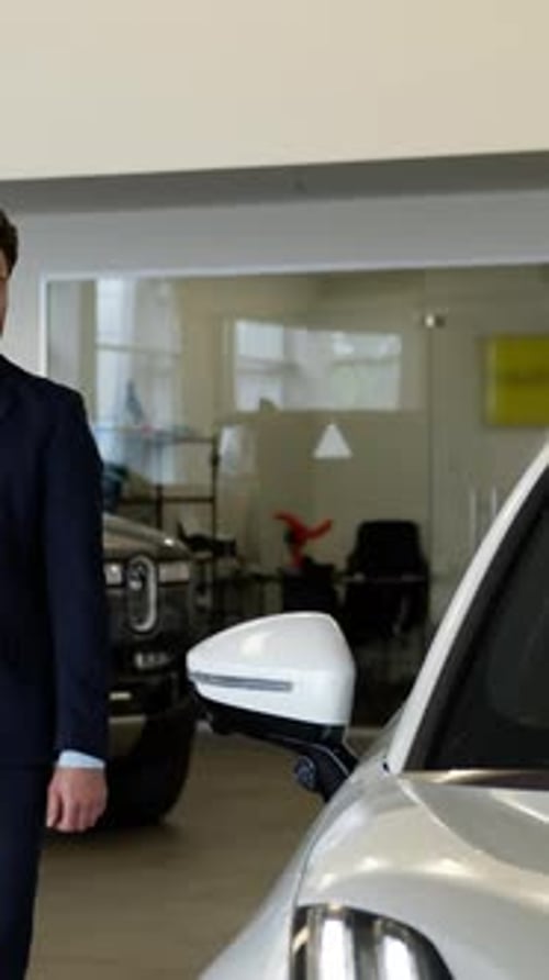 Serious Thinking Caucasian Businessman Touching Car Auto Indoor Dealership Man Male Client Buyer