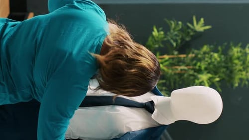 Woman Dresses Mannequin in Business Suit and Tie