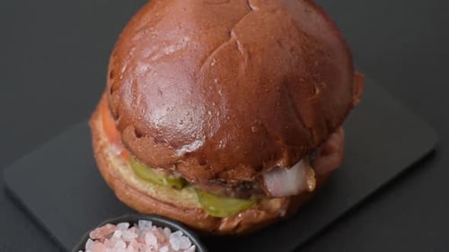 Delicious Burger with Bacon, Pickles, and Tomatoes