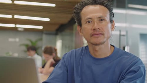 Man Posing Seriously in an Office Environment