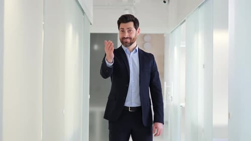 Confident Businessman Invites with Handshake and Thumbs Up