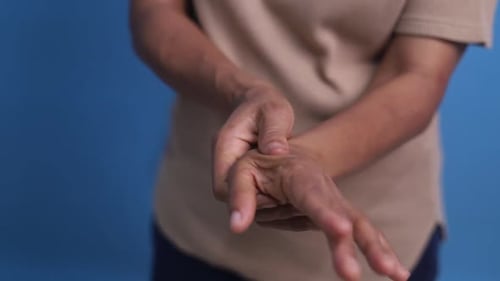 The hands of Asian elderly woman have pain to the fingers. Health and Physical Concepts