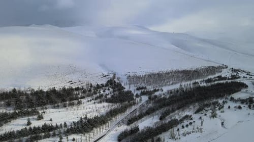Snowy Mountain Landscape Aerial View on Cloudy Day