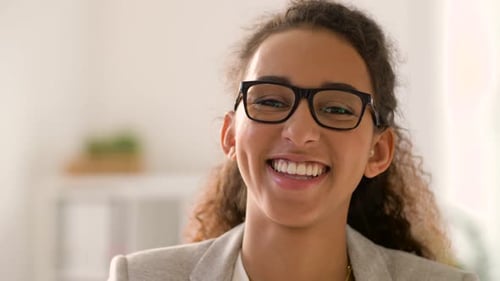 Cheerful young woman smiling and adjusting her hair