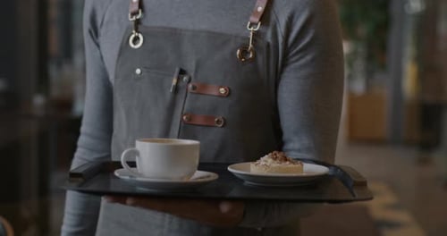 Nahaufnahme eines männlichen Handkellners in Zeitlupe, Tragetablett mit Kaffeetasse und Nachtisch, in dem Essen serviert wird