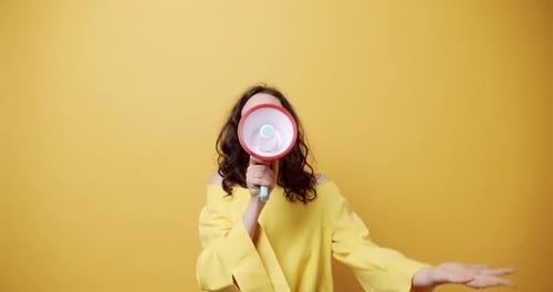 Woman Announcing with a Megaphone in Studio Setting