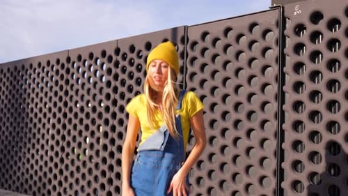 Enthusiastic Young Woman Dancing in Urban Setting