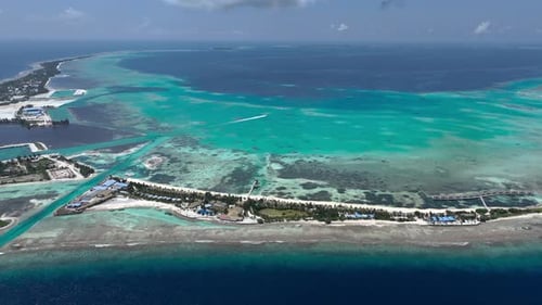 Aerial view of luxury resort, turquoise waters, reef, Maldives.