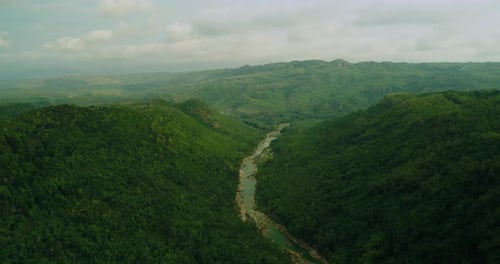 Drone aerial view of river between forest hills