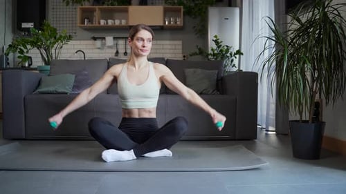 Woman Working Out at Home with Dumbbells