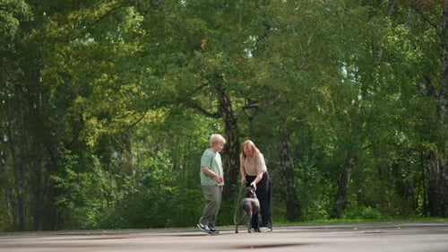 Woman and Boy with Dog Standing in Park