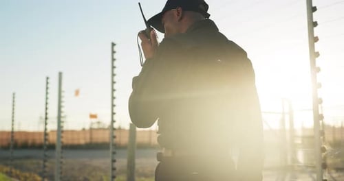 Security Guard Communicating on Walkie Talkie