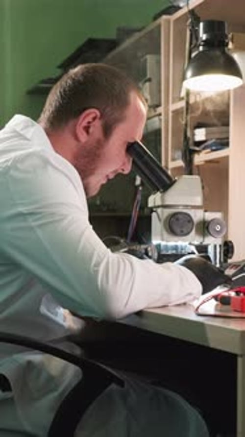 Focused Scientist Using a Microscope in Laboratory