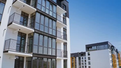 Modern multi-storey building. Large glazed balconies of the new high-rise building.