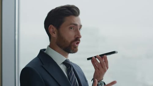 Angry Ceo Manager Calling on Smartphone Gesturing at Office Window Close Up