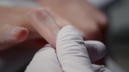 Woman Receiving Manicure at Nail Salon Close Up