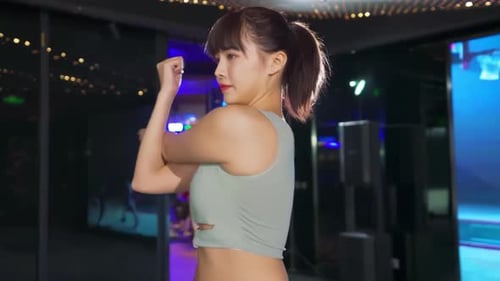 Fit attractive woman doing stretch stretching hands for warm up before sport workout in gym club