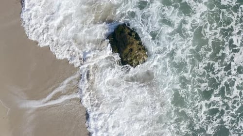 Waves Crashing on Rock Aerial Beach Scene