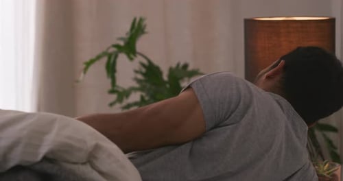 Man Wakes Up and Sits Up in Bed