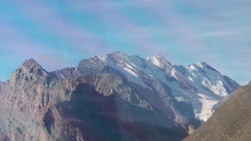 The towering mountain landscape offers a magnificent aura. The daytime unveils snow-covered mountain