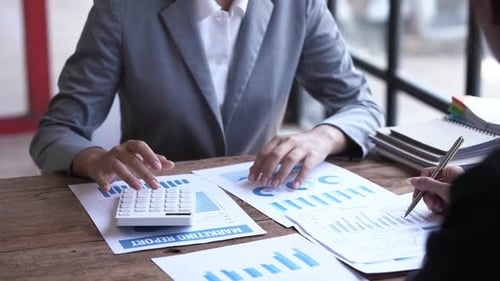 Financial analyst analysis business financial report on digital tablet during discussion at meeting