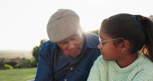 Sunrise, grandfather and girl talking in park for bonding, quality time and conversation outdoors