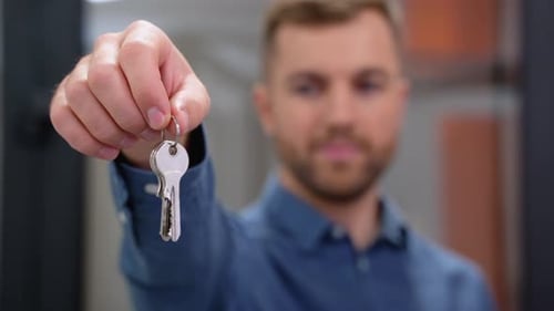Close Up of Friendly Manager in Window Shop with Keys