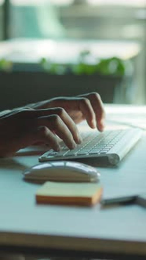 Hands Typing on a Keyboard and Using Mouse