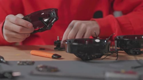 Closeup Shot of Caucasian Research Engineer Making Electronic First Person View Drone Enjoying