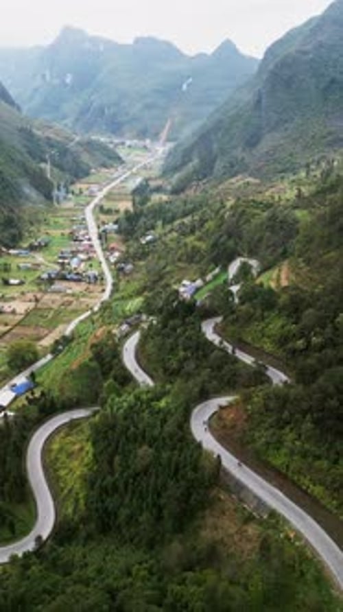 Vertical Aerial Footage of Serpentine Road and Rural Village in Northern Vietnam Highlands