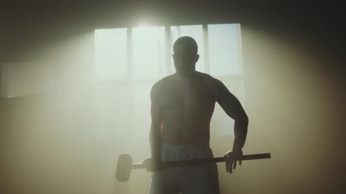 Muscular Man Doing Tire Workout With Sledgehammer