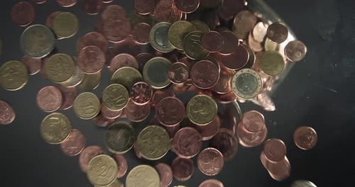 Closeup of Pouring Euro Coins on the Table