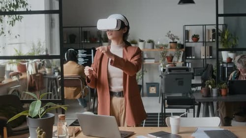 Female Software Developer Using VR Headset in Office