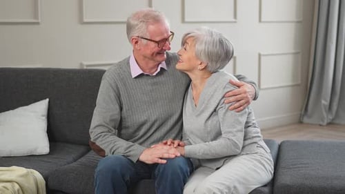 Affectionate Senior Couple Relaxing Together at Home