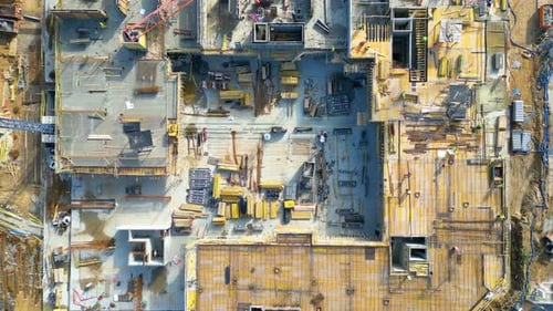 Aerial Flight Over a New Constructions Development Site with High Tower Cranes Building Real Estate.