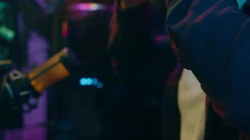 Man with headphones speaking into microphone